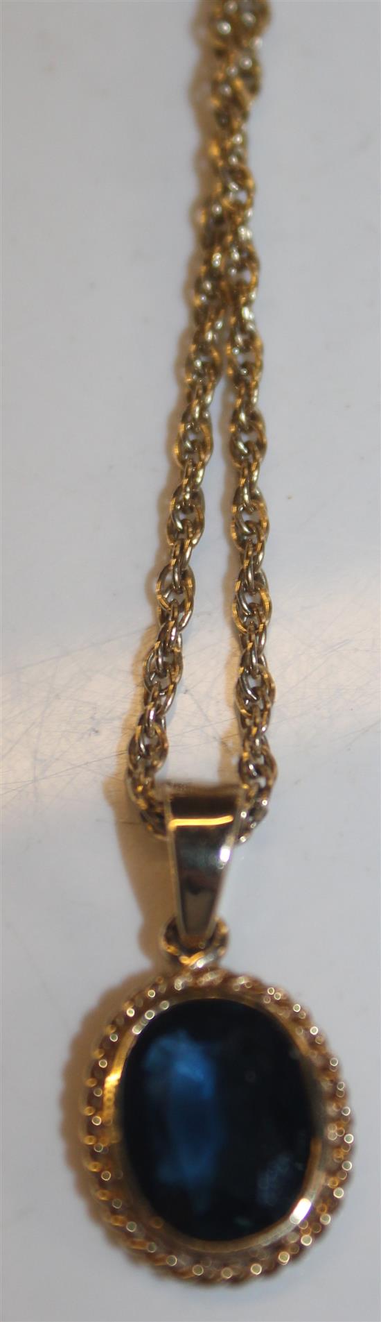 A gold and sapphire pendant on 9ct gold chain